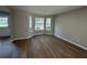 Open living room featuring large bay windows with updated luxury vinyl plank flooring at 4189 Post Oak Grv, Atlanta, GA 30349