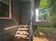 Back entrance features metal security door and small staircase with adjacent green space at 1373 Lucile Sw Ave, Atlanta, GA 30310