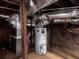 This is a basement with ductwork, a water heater and a red brick wall at 1373 Lucile Sw Ave, Atlanta, GA 30310