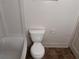 Small bathroom with toilet and a partial view of the tub at 1373 Lucile Sw Ave, Atlanta, GA 30310