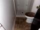 Small bathroom featuring shower, toilet with brown seat cover, and tile floor at 1373 Lucile Sw Ave, Atlanta, GA 30310