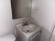 A small bathroom with toilet and vanity with sink and standard faucet at 1373 Lucile Sw Ave, Atlanta, GA 30310