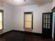 Sunlit room with dark trim and wood floors showcasing multiple windows and glass panel doors at 1373 Lucile Sw Ave, Atlanta, GA 30310