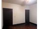 Spacious bedroom features dark trim, wood floors, and two dark doors at 1373 Lucile Sw Ave, Atlanta, GA 30310