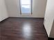 This is an interior shot of a bedroom with dark, wood-patterned floors and a window at 1373 Lucile Sw Ave, Atlanta, GA 30310