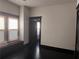 View of the bedroom with hardwood floors, a large window, and doorway to the next room at 1373 Lucile Sw Ave, Atlanta, GA 30310