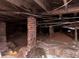 The crawl space has brick supports, wooden beams, and evidence of moisture mitigation measures at 1373 Lucile Sw Ave, Atlanta, GA 30310