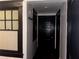 Hallway featuring dark wood trim, a window, and dark wooden doors at 1373 Lucile Sw Ave, Atlanta, GA 30310