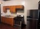 Kitchen features stainless steel appliances, wood cabinets, and a laminate countertop at 1373 Lucile Sw Ave, Atlanta, GA 30310