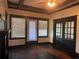View of the living room with hardwood floors, a fireplace, french doors, and large windows at 1373 Lucile Sw Ave, Atlanta, GA 30310