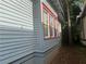 A side exterior view of the home features blue siding and red window trim at 1373 Lucile Sw Ave, Atlanta, GA 30310
