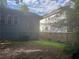 Side exterior featuring blue siding and red window trim. Adjacent home and fenced in area at 1373 Lucile Sw Ave, Atlanta, GA 30310