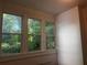 Cozy sunroom featuring three windows offering views of lush greenery at 1373 Lucile Sw Ave, Atlanta, GA 30310