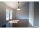 Bright dining area featuring dark hardwood floors, fresh paint, and double doors leading to the deck at 2333 Wilkins Cv, Decatur, GA 30035