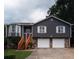 Charming two-story home featuring gray siding, stone accents, wood stairs, and a well-maintained front yard at 2333 Wilkins Cv, Decatur, GA 30035
