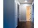 Hallway showcasing dark hardwood floors and access to a well-lit bathroom, creating a seamless flow at 2333 Wilkins Cv, Decatur, GA 30035