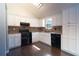 Updated kitchen with black appliances, white cabinets, and modern backsplash at 2333 Wilkins Cv, Decatur, GA 30035
