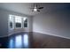 This living room boasts hardwood flooring, neutral paint, a ceiling fan, and large bay windows at 2333 Wilkins Cv, Decatur, GA 30035
