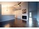Spacious living room with hardwood floors, a fireplace, and stylish lighting, perfect for relaxation and gatherings at 2333 Wilkins Cv, Decatur, GA 30035