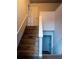 Stairway with hardwood steps and white trim leading to upper and lower levels at 2333 Wilkins Cv, Decatur, GA 30035