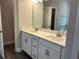 Bathroom featuring double sinks, white cabinets, and a large mirror at 3383 Milan Ct, Douglasville, GA 30135