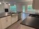 Modern kitchen with stainless steel appliances, granite countertops, and custom cabinetry at 3383 Milan Ct, Douglasville, GA 30135