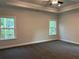 Spacious main bedroom with plush carpet, two windows and trey ceilings at 3383 Milan Ct, Douglasville, GA 30135