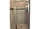 Tiled shower with sliding glass doors and stylish accent tiles at 3383 Milan Ct, Douglasville, GA 30135