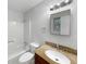 Well-lit bathroom featuring granite countertops, white cabinetry, and a shower-tub combination at 3867 Cherie Glen Rd, Snellville, GA 30039