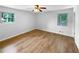 Bright bedroom with two windows, gleaming wood floors, and neutral walls at 3867 Cherie Glen Rd, Snellville, GA 30039