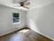 Bedroom with ceiling fan, hardwood floors, and a bright window at 3867 Cherie Glen Rd, Snellville, GA 30039