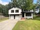 Charming two-story home with a well-manicured lawn and two-car garage offering curb appeal at 3867 Cherie Glen Rd, Snellville, GA 30039