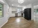 Functional kitchen with stainless steel appliances, white cabinets, and hardwood floors at 3867 Cherie Glen Rd, Snellville, GA 30039