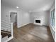 Bright living room with a cozy fireplace and neutral gray walls, and gleaming wood floors at 3867 Cherie Glen Rd, Snellville, GA 30039