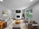 Bright living room with a cozy fireplace and neutral decor, staged with stylish furniture at 3867 Cherie Glen Rd, Snellville, GA 30039