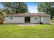 Backyard featuring a green lawn, a patio area and the home's neutral-colored exterior at 183 Peachtree Ct, Riverdale, GA 30274