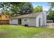 The backyard features a lush lawn and mature trees, perfect for outdoor activities at 183 Peachtree Ct, Riverdale, GA 30274