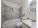 Bathroom featuring a shower-tub combo with white tile and a modern sink at 183 Peachtree Ct, Riverdale, GA 30274