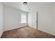 A simple empty bedroom with neutral walls, carpeted floor and a bright window at 183 Peachtree Ct, Riverdale, GA 30274