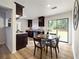 Eat-in kitchen with modern dark wood cabinets, stainless steel appliances, and sliding doors to the backyard at 183 Peachtree Ct, Riverdale, GA 30274