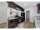 This kitchen offers stainless steel appliances and dark wood cabinets at 183 Peachtree Ct, Riverdale, GA 30274