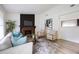 Living room featuring a stone fireplace, modern furnishings, neutral color, and plenty of natural light at 183 Peachtree Ct, Riverdale, GA 30274