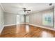Spacious bedroom featuring hardwood floors, patterned wallpaper, and natural light from large windows at 5190 Due West Nw Rd, Powder Springs, GA 30127