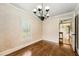 Charming dining room with hardwood floors, decorative wallpaper, and stylish chandelier at 5190 Due West Nw Rd, Powder Springs, GA 30127