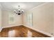Dining room featuring hardwood floors, neutral walls, and plantation shutters at 5190 Due West Nw Rd, Powder Springs, GA 30127