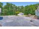 Exterior view of property featuring a detached garage with a basketball hoop and well-kept grounds at 5190 Due West Nw Rd, Powder Springs, GA 30127