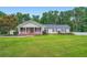 Well maintained single-story home with a landscaped lawn and inviting front porch at 5190 Due West Nw Rd, Powder Springs, GA 30127