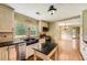 Bright kitchen featuring modern appliances, granite countertops, and hardwood flooring at 5190 Due West Nw Rd, Powder Springs, GA 30127