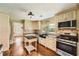 Well-lit kitchen with stainless steel appliances, custom cabinets, and black granite countertops at 5190 Due West Nw Rd, Powder Springs, GA 30127