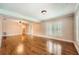 Open-concept living room featuring gleaming hardwood floors, neutral walls, and plantation shutters at 5190 Due West Nw Rd, Powder Springs, GA 30127